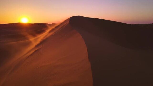 Desert sunset over windblown dune. Lone sand ridge silhouette for drought and adventure travel.