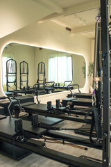 Fototapeta premium Modern Pilates Studio Interior Featuring Premium Black Reformer Machines