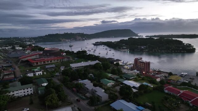 Aerial drone view of Port Vila, the capital of Vanuatu, its harbor dotted with yachts at dusk on a South Pacific island.