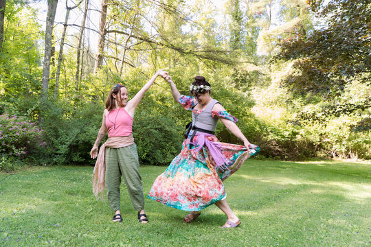 Women dancing in colorful fairy outfits