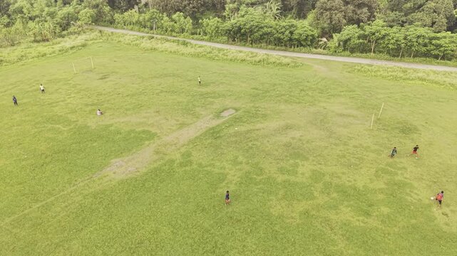 KUSHTIA, BANGLADESH &ndash; JUNE 12, 2026: Drone footage of children playing football on a rural grass field, documenting everyday community sports and outdoor recreation in Bangladesh.