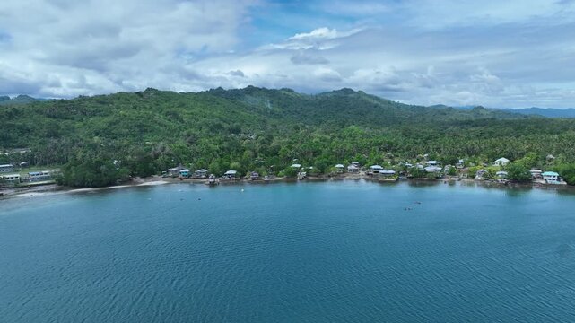 Malaita, Solomon Islands - seaside village along a calm lagoon on a remote island, aerial drone view