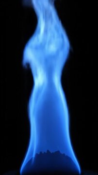 Hypnotic blue flame burning steadily against a dark background in a slow motion macro shot
