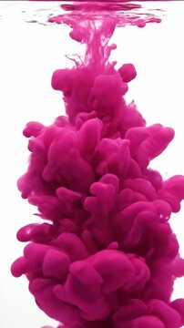 Pink ink billowing upward in clear water against a white background for abstract fluid art