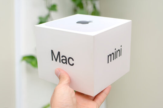Zapopan Jalisco, Mexico - June 30, 2026: Title: Hand holding Apple Mac mini M4 retail box for a technology product unboxing review