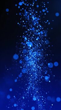 Shimmering blue particles floating upwards in an ethereal and magical abstract background