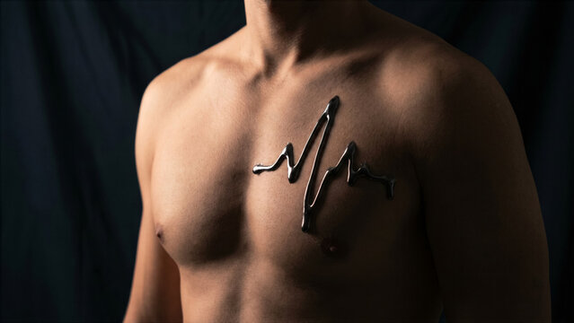 Conceptual close up of male chest with fluid poured iron line mimicking heartbeat wave pattern