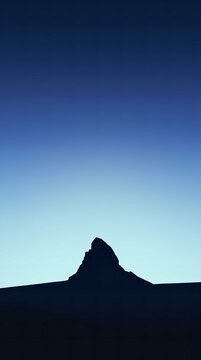Silhouette of Mountain Peak at Twilight with Clear Sky Gradient