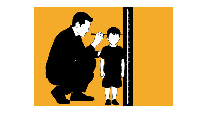 Adult measuring child height against wall chart.