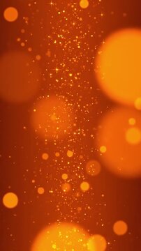 Vertical abstract background with shimmering orange light particles and soft bokeh in slow motion