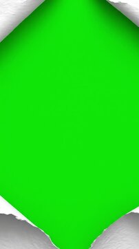 White textured paper ripping apart vertically to reveal a green screen for video transitions