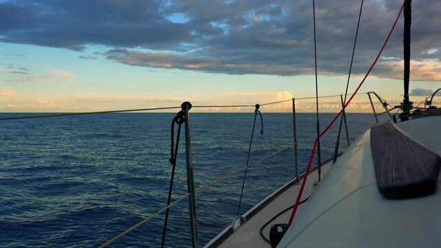 Sailboat sailing on the ocean at sunset