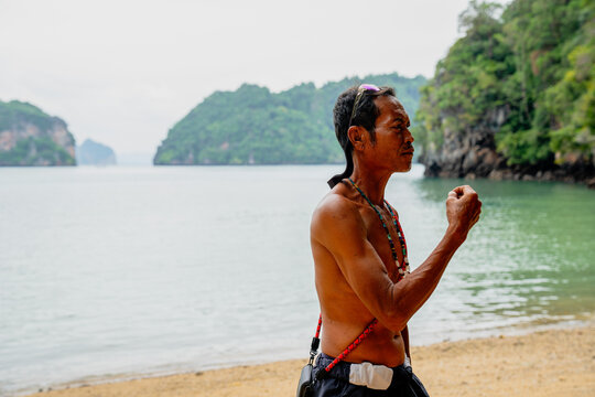 Man looking out at tropical island beach