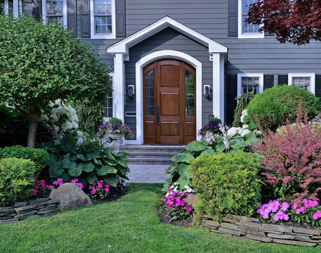 House with attractively landscaped front garden and elegant wood grain front door