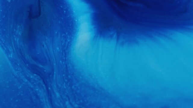 Paint fluid. Pigment liquid. Blue acrylic stream mix blend. Color fizz splatter diffusion abstract emulsion spread defocused background.