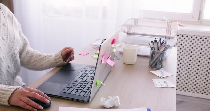 Remote job. Office worker. Unrecognizable woman professional typing on computer searching information online at home workspace.