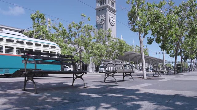 19th Century Ferry Building Clock Tower With Streetcar Passing Plaza - Wide Establishing Shot In San Francisco