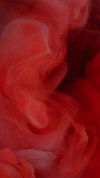Vertical video. Smoke background. Cloud ink. Defocused orange blue colorful ethereal fume liquid exhaust chemical texture wave on art abstraction.