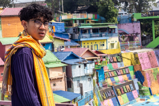 a young man with glasses and scraf in "colorfull" vilage in Malang