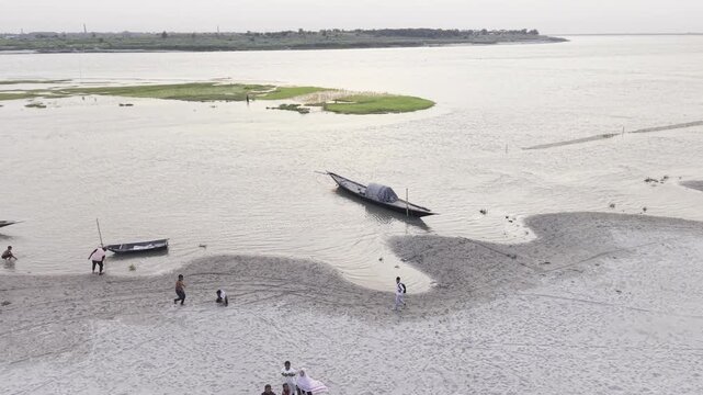 Aerial footage of visitors exploring a sandy riverbank at the Padma-Gorai River Confluence in Kushtia, Bangladesh, filmed on June 27, 2026. 