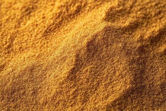 close-up of warm golden granular powder with soft ridges evoking cozy earthy warmth