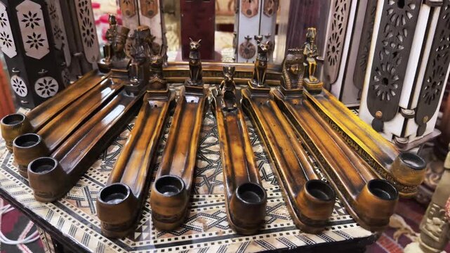 Wooden incense stick holders arranged in row inside souvenir shop