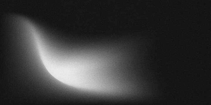 Monochrome grainy noise texture abstract background featuring soft curved pale light gradient on deep black base, ample blank copy space.