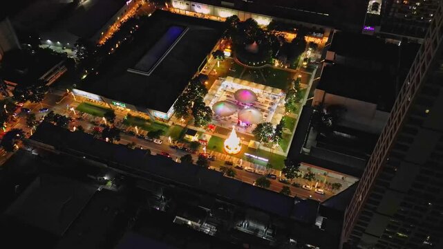 Wide establishing aerial shot of Greenfield District along Shaw Boulevard in Mandaluyong City Metro Manila Philippines showcasing modern skyscrapers and urban development during night time.