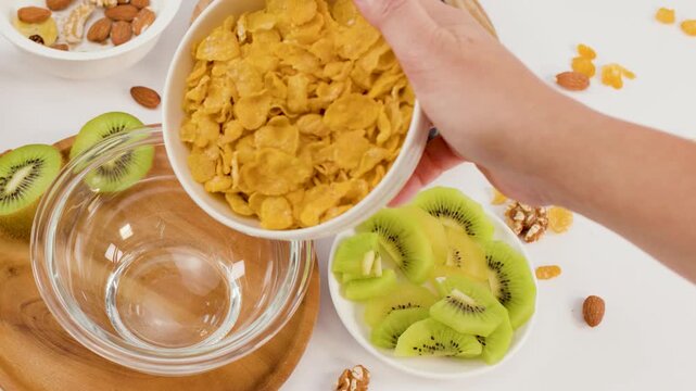 Pouring Golden Corn Flakes into Glass Bowl for Healthy Breakfast