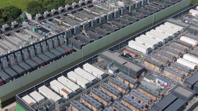Aerial view of a large data center facility with rows of cooling units and server infrastructure in London, London, United Kingdom.
