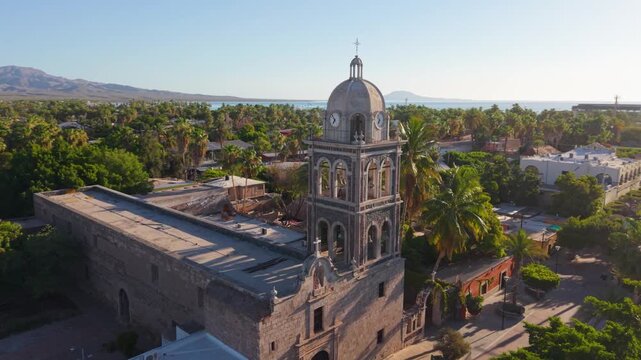 Watch sunrise views of Loreto Mission church in Baja California Sur, Mexico from the air, capturing the beauty of the region and the church.