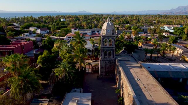 Aerial views capture the sunrise illuminating the Loreto Mission church in Baja California Sur, Mexico, showcasing its historic charm