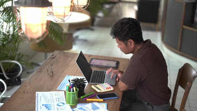 Businessman Using Calculator and Analyzing Stock Market Chart with Money for Financial Planning, Accounting, Business Strategy and Investment Analysis Concept
