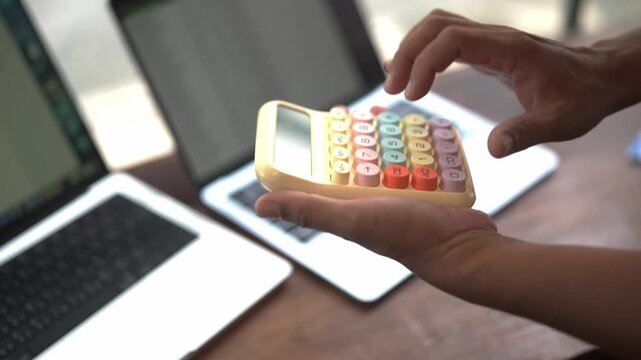 Close Up of Hand Holding  Calculator for Financial Planning, Business Accounting, Online Payment Technology and Money Management Concept
