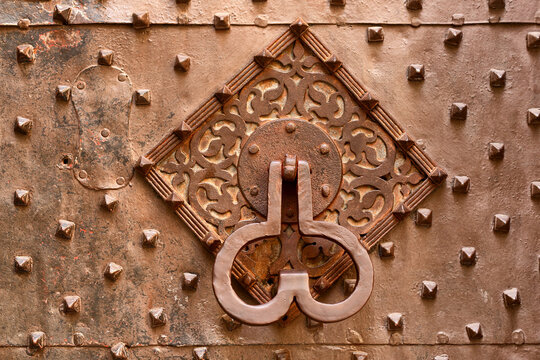 Door knocker on a exetrior building door of a historic building in Genova