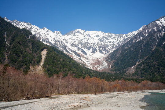 Snow covered mountain landscape with clear blue sky, nature and scenic wilderness.