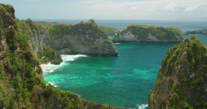 Scenic view of rocky islets in emerald sea from cliff top at Diamond Beach in Nusa Penida Bali
