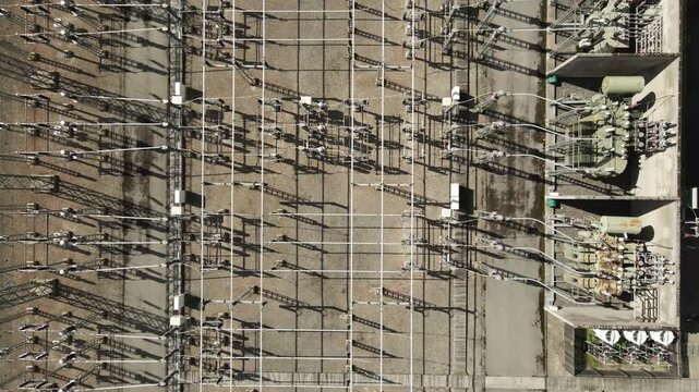 High voltage electrical substation with transformers and power lines seen from above, a crucial component of the energy infrastructure for power generation and electricity distribution