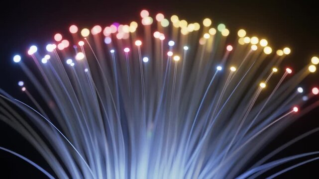 Close‑up of glowing multicolor fiber‑optic strands radiating outward on dark background, symbolizing high‑speed data transmission and modern connectivity.