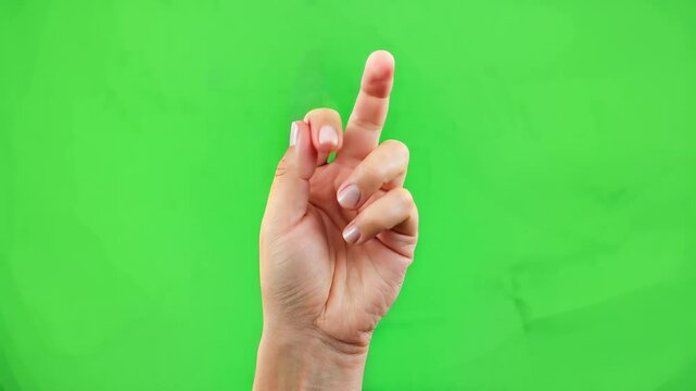 Close-up hand gesture with index finger and thumb forming a cross, vibrant green background, symbolizing decision making, focus, and concentration