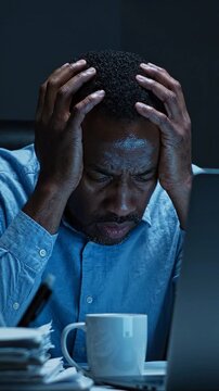 An Exhausted Individual Struggles with Stress and Overwhelm While Working Late at Night, Capturing the Emotional Toll of Modern Work Environments