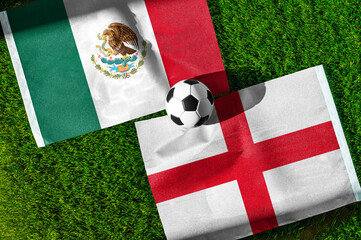 Mexico vs England, national flags before international football match, football on green grass with...