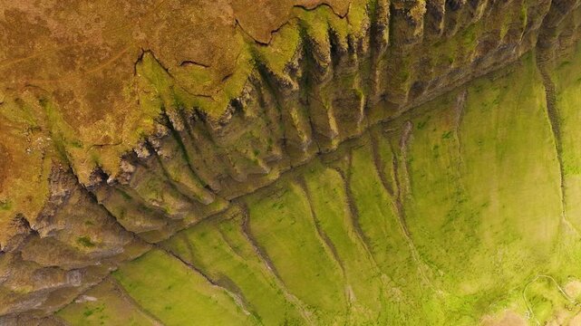 Cinematic drone shot of Ben Bulben table mountain in Sligo, Ireland. Famous flat-topped landmark with green countryside and majestic rock cliffs.