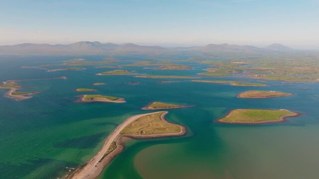 Spectacular drone footage of Clew Bay in County Mayo, Ireland. Cinematic aerial perspective of the legendary drumlin island archipelago, blue ocean waters, and rugged West Coast
