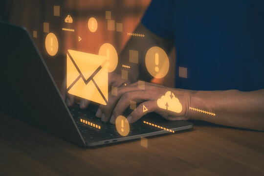 Man typing on laptop with email alert hologram. Cloud technology, digital business communication, spam warning and internet message concept.