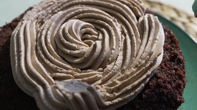 Chocolate frosting piping cake decorating swirl sweet dessert making on kitchen table top view macro video