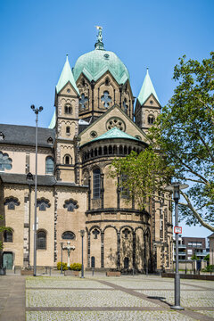 Basilica of St. Quirinus in Neuss Germany with a bustling market in front