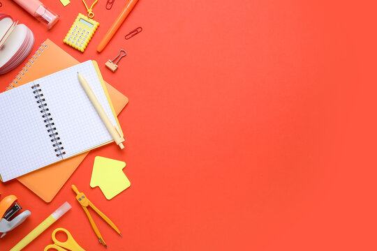 Different school stationery supplies on red background