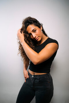 Confident young woman posing with curly hair