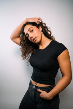 Young adult woman posing with confidence in studio